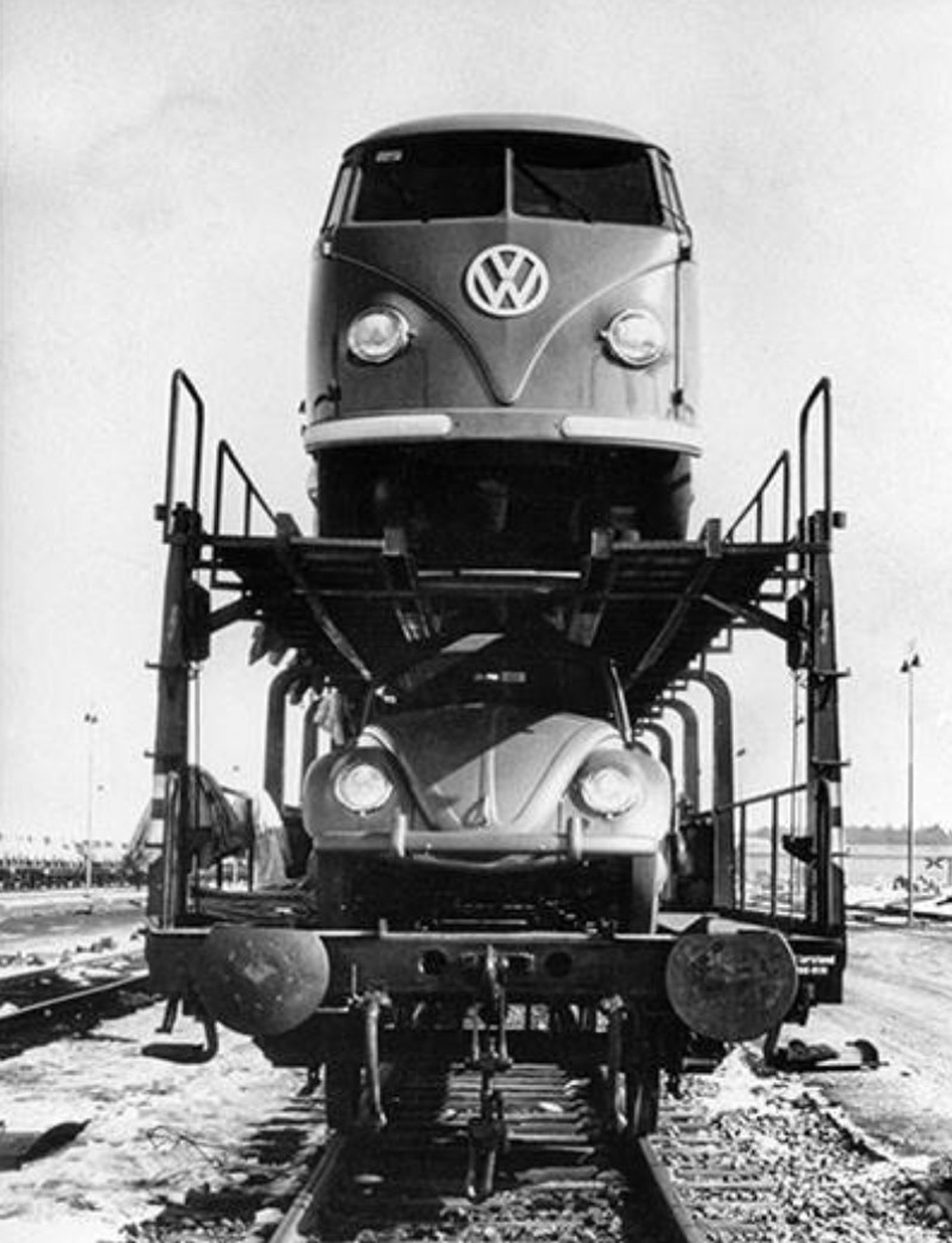 New Volkswagens wait on a double-deck rail wagon in a train yard somewhere in Germany