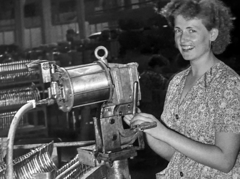 One of many workers in the Volkswagen factory at Wolfsburg is pictured smiling at her workstation