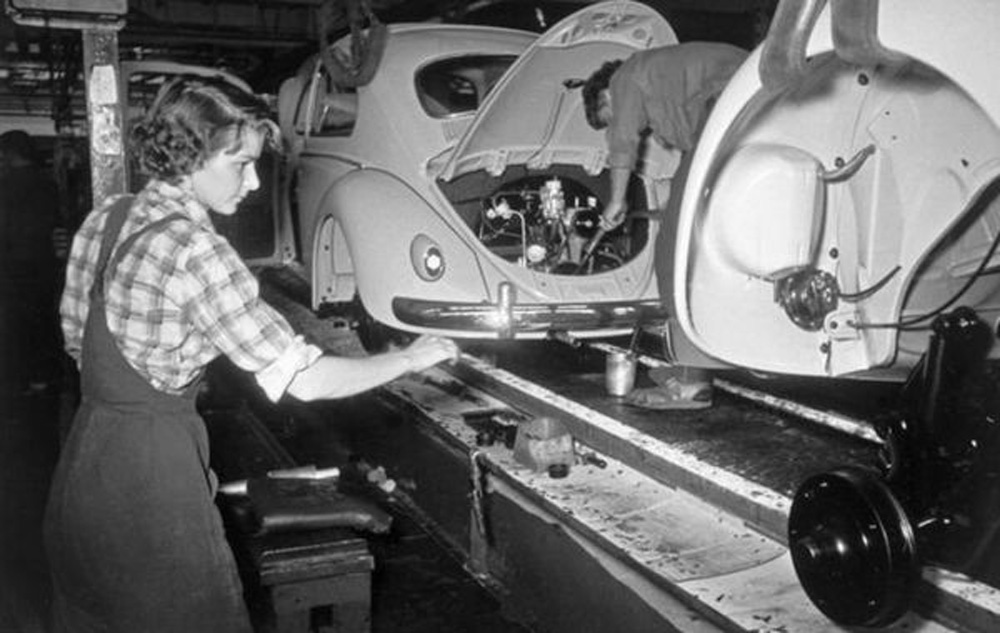 A 
        worker in the final assembly hall at Volkswagenwerk Wolfsburg