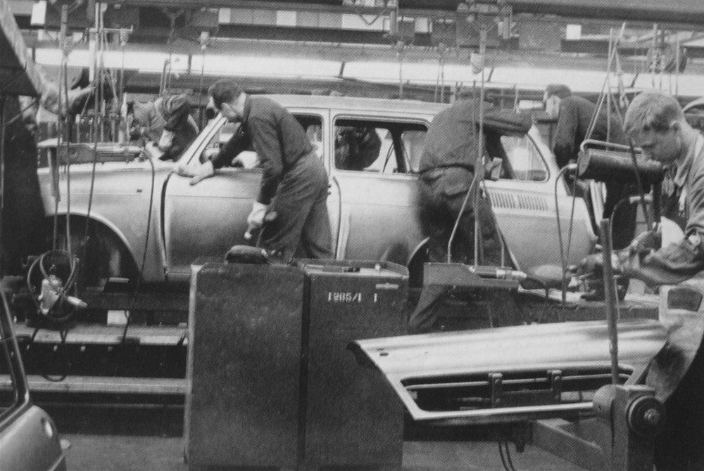 Line 
        workers deburring and grinding the bare metal bodyshell of a VW Type 3