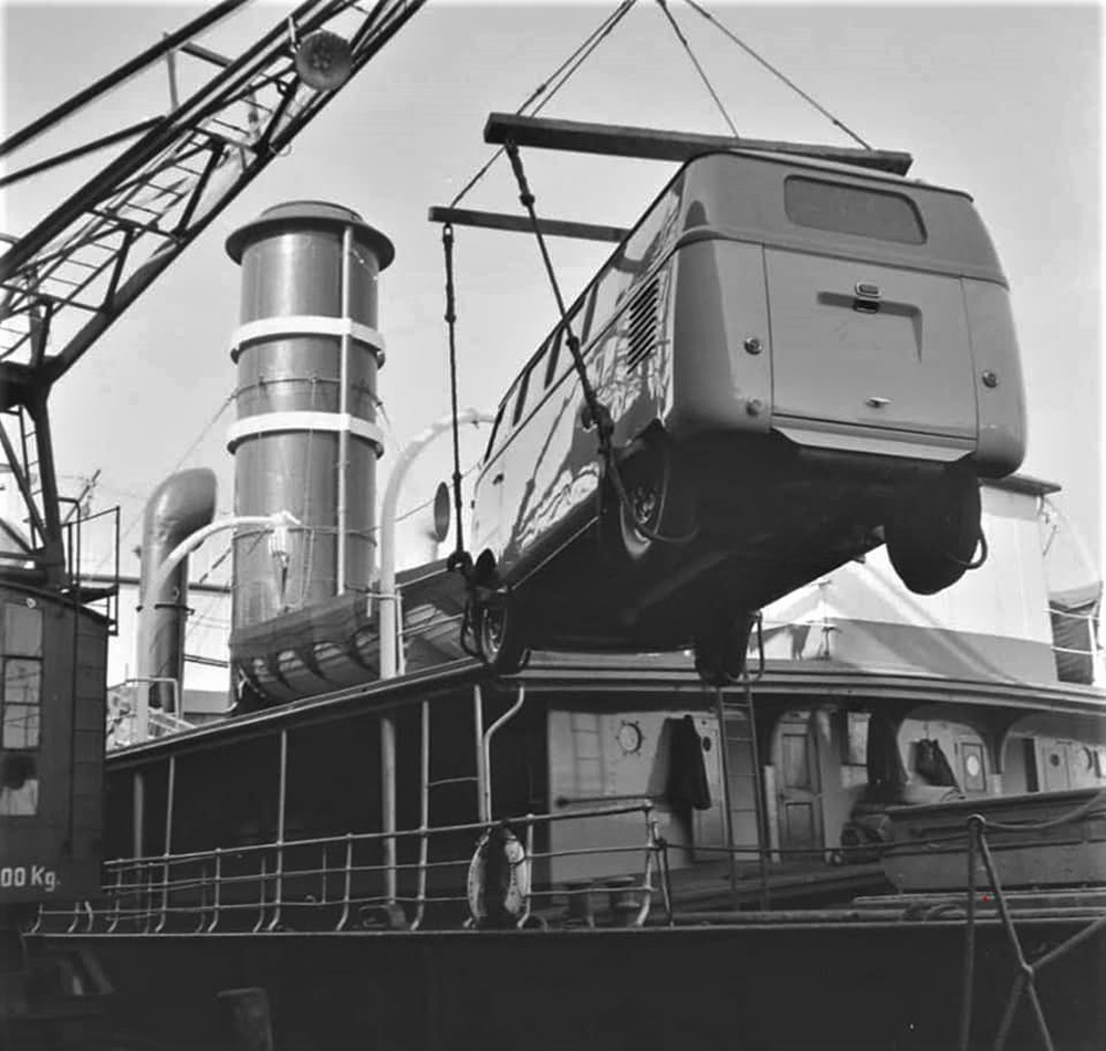 A 
        barndoor bus is lifted on board