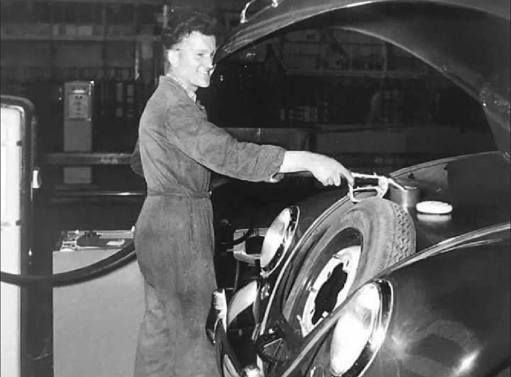 Pumping 
        a few litres of fuel into the tank on a newly completed Volkswagen