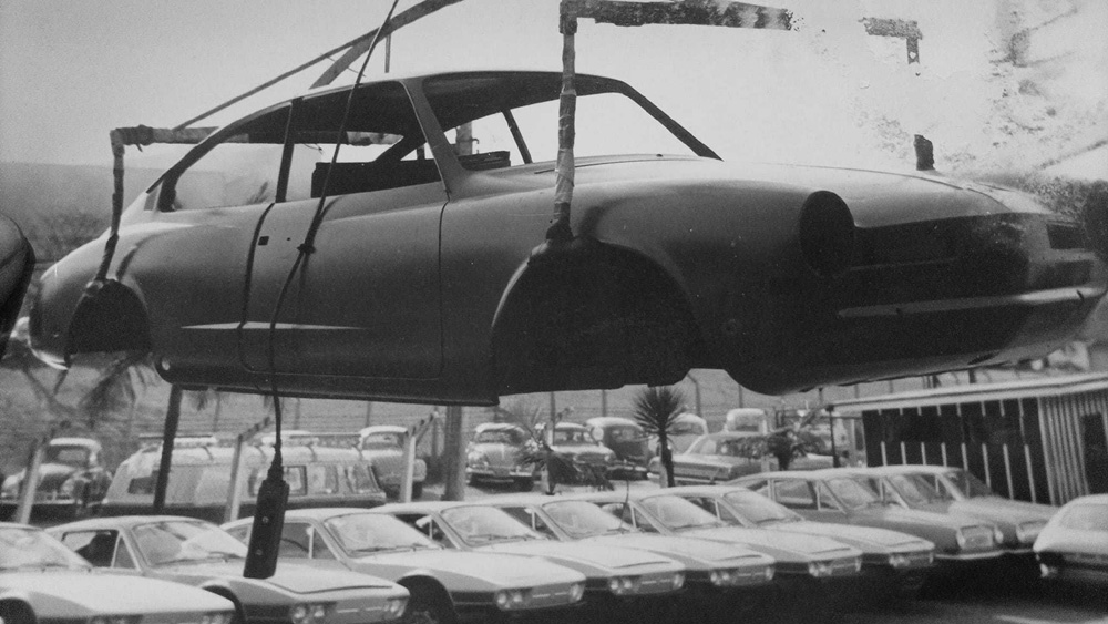 A 
        bodyshell in primer of a Karmann Ghia TC