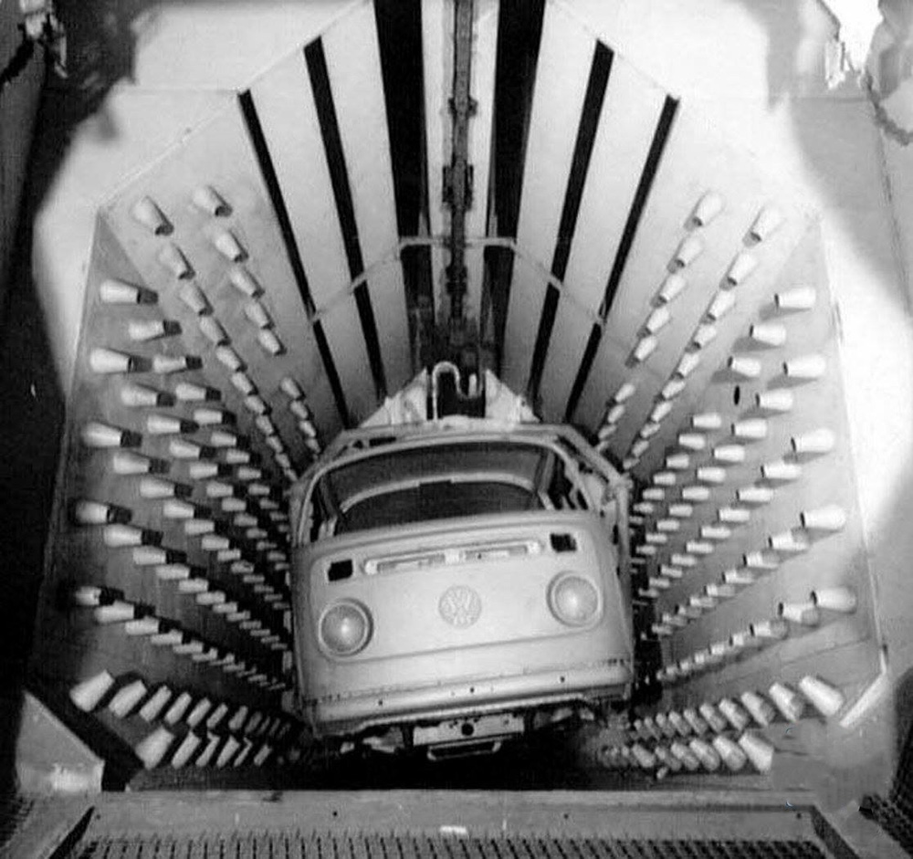 A 
        Type 2 Kombi enters the drying booth in the paint shop